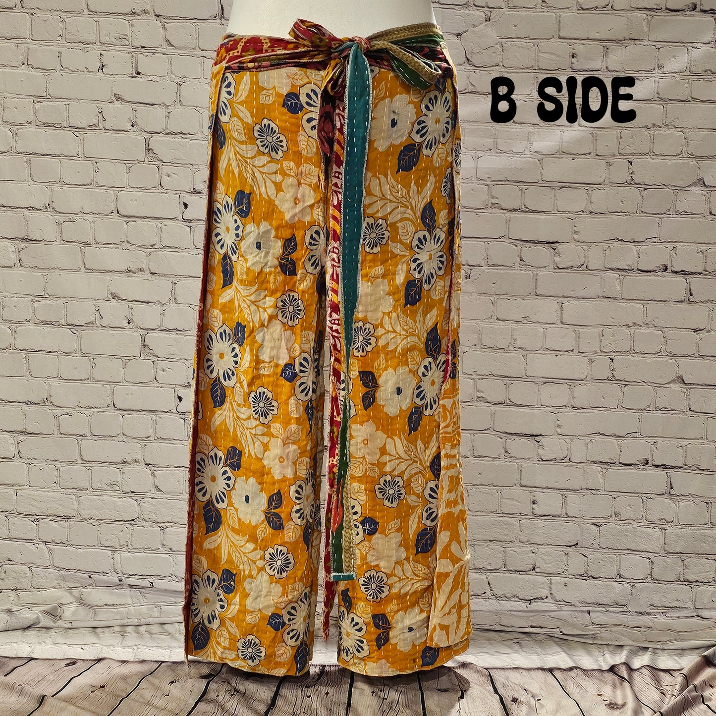 Front view of Ronin Kantha unisex wrap pants, made from recycled sari fabric in boho patchwork design.