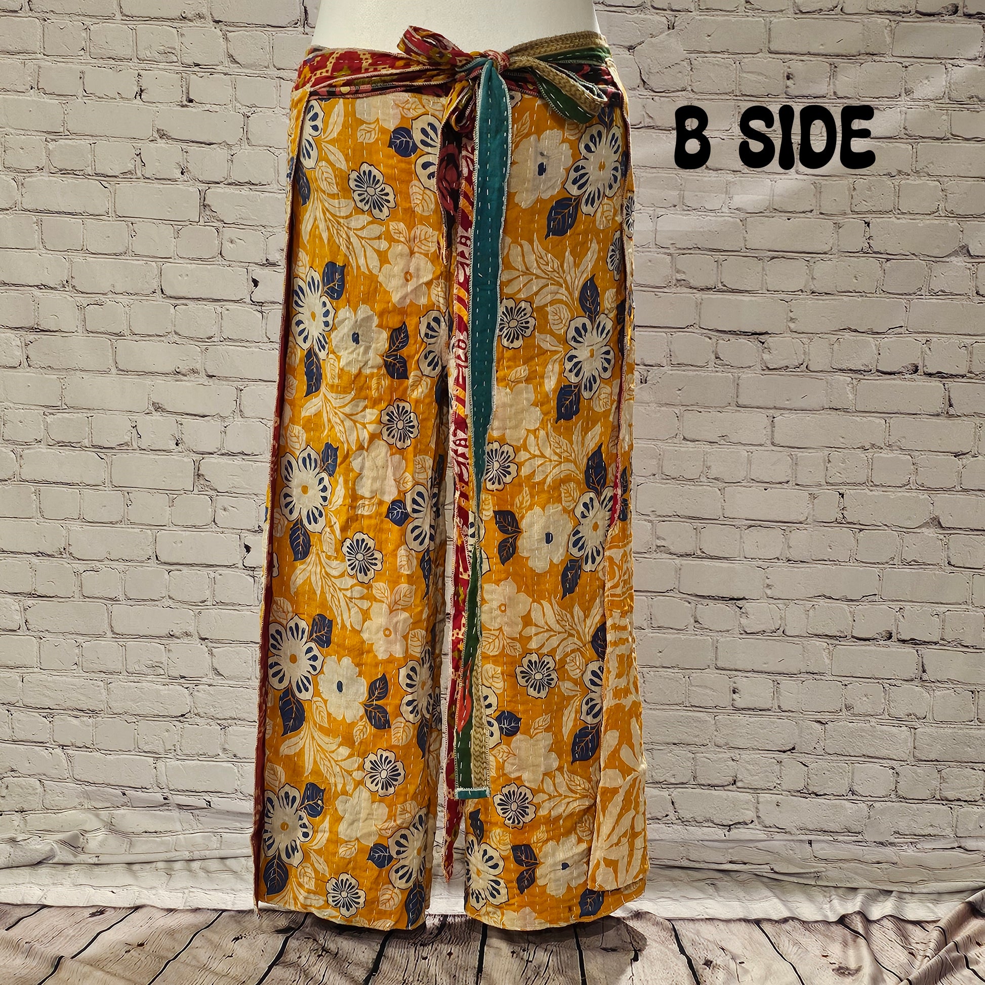 Front view of Ronin Kantha unisex wrap pants, made from recycled sari fabric in boho patchwork design.