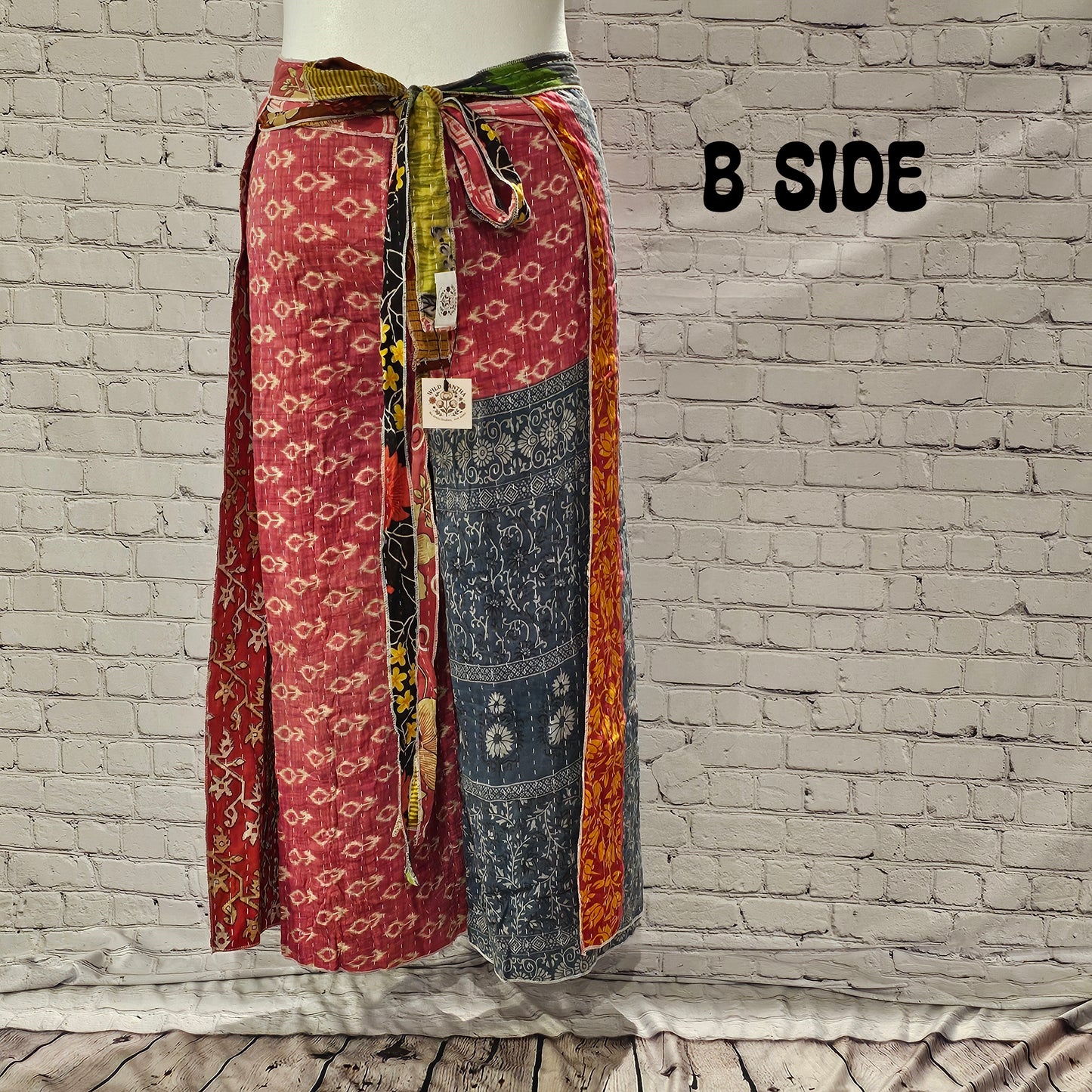 Front view of Ronin Kantha unisex wrap pants, made from recycled sari fabric in boho patchwork design.