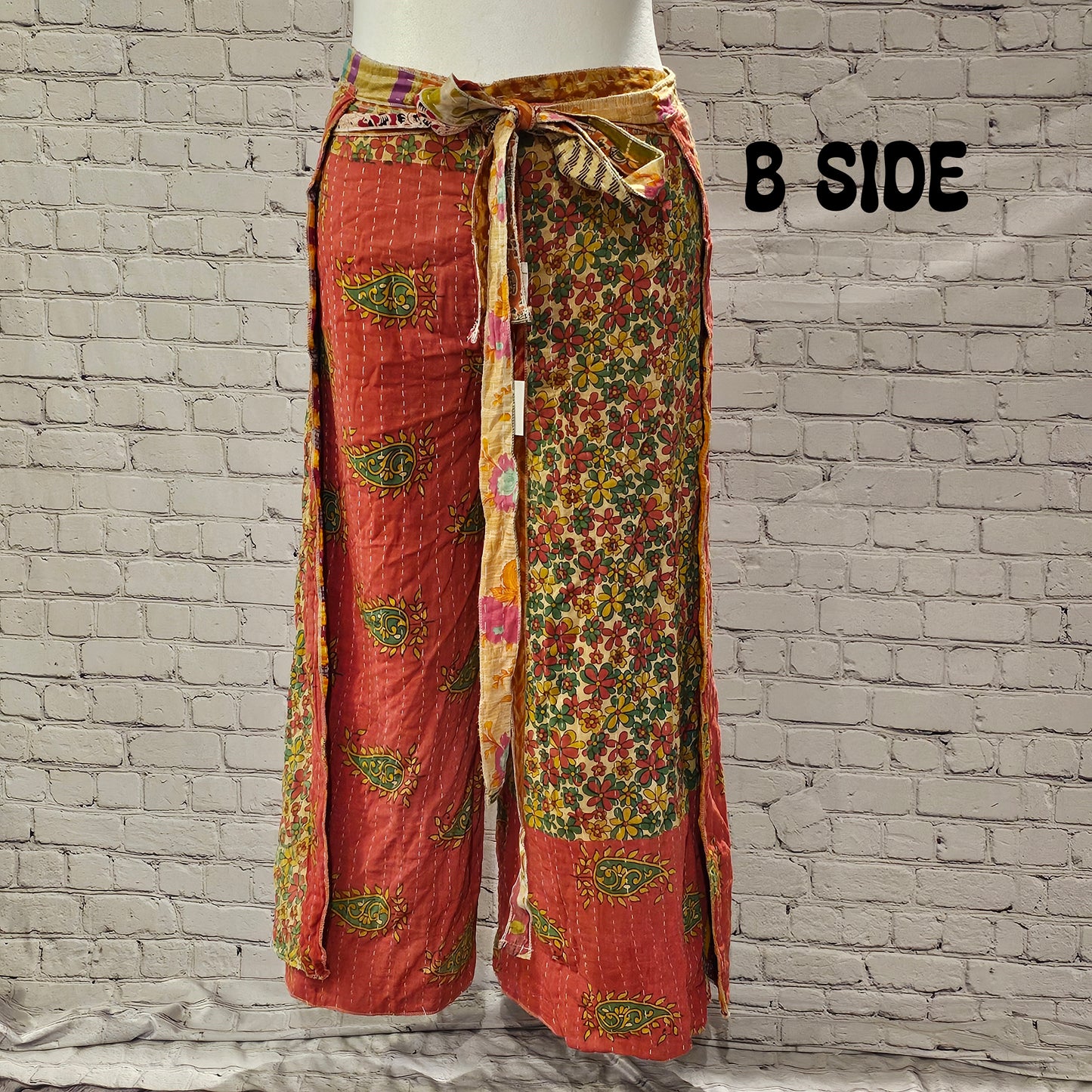Front view of Ronin Kantha unisex wrap pants, made from recycled sari fabric in boho patchwork design.