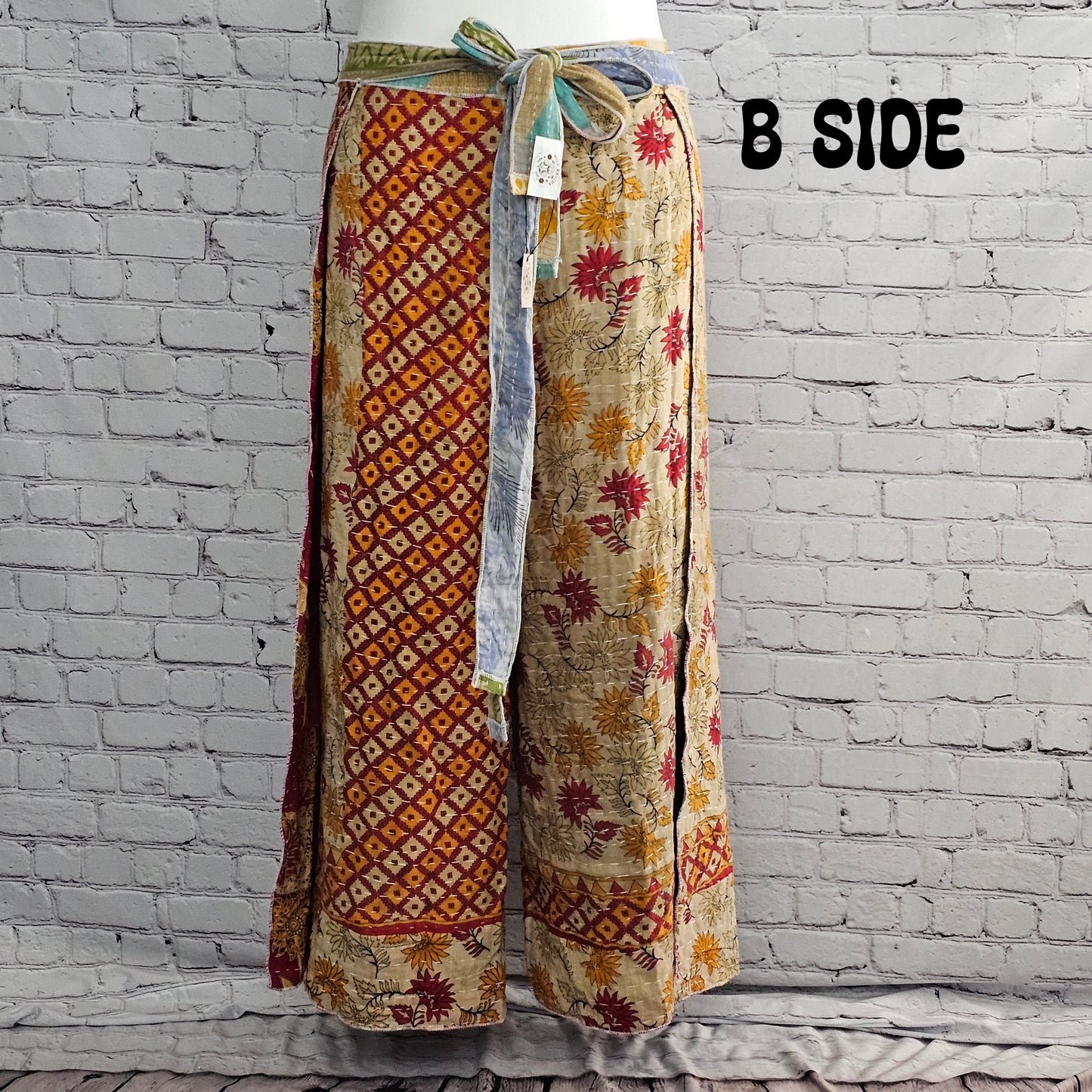 Front view of Ronin Kantha unisex wrap pants, made from recycled sari fabric in boho patchwork design.