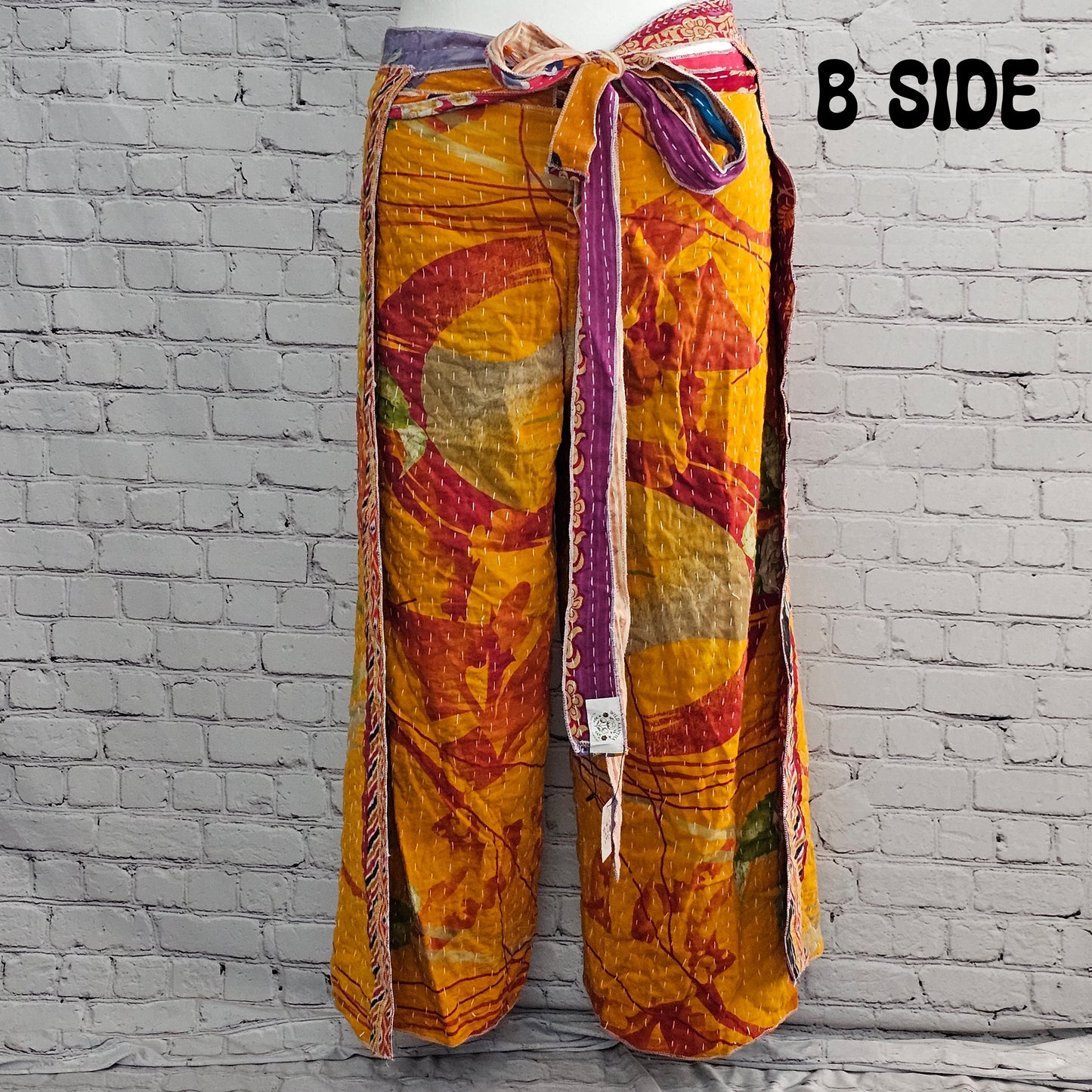 Bohemian reversible Kantha wrap pants on model, eco-friendly unisex loungewear.