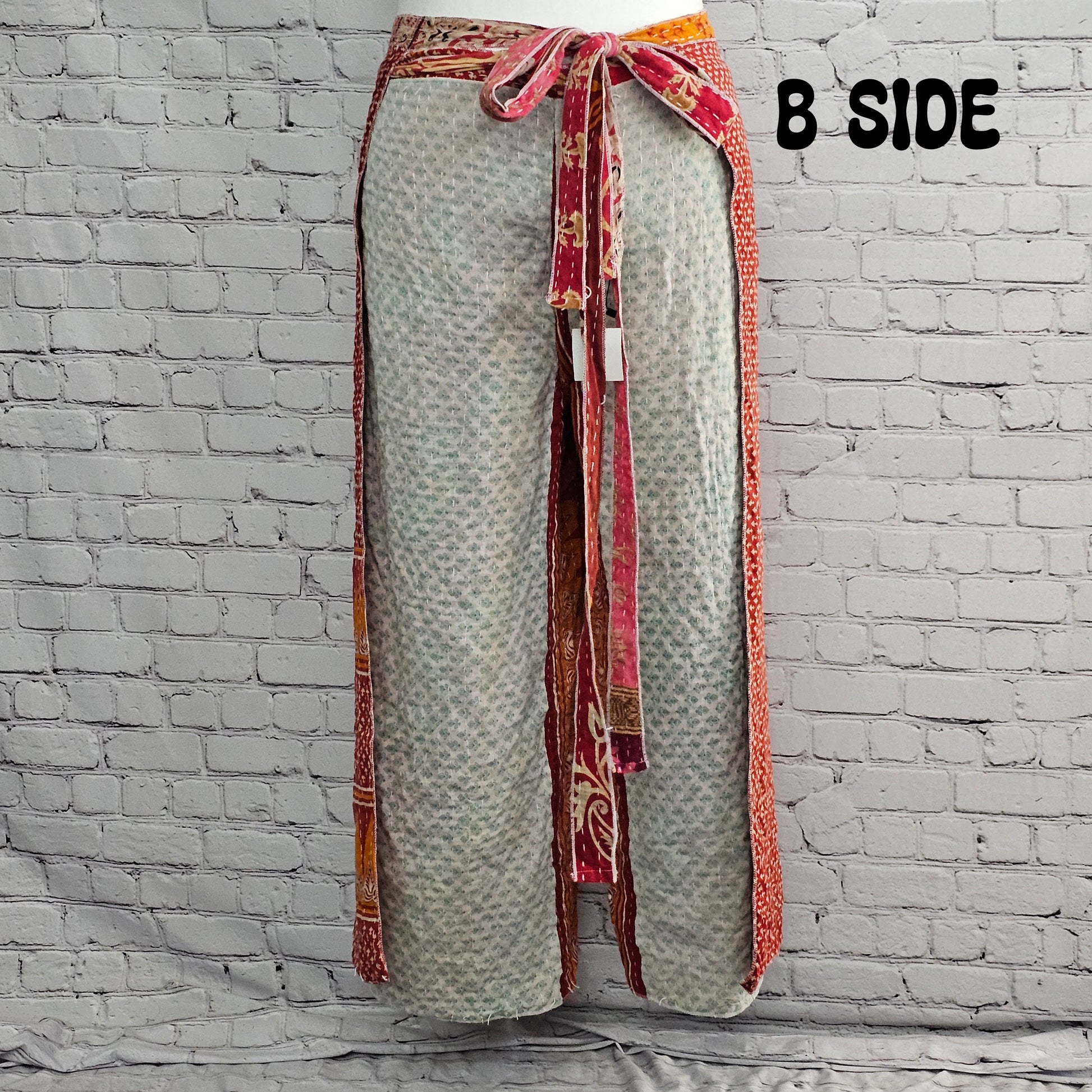 Front view of Ronin Kantha unisex wrap pants, handmade from recycled sari fabric in boho patchwork design.