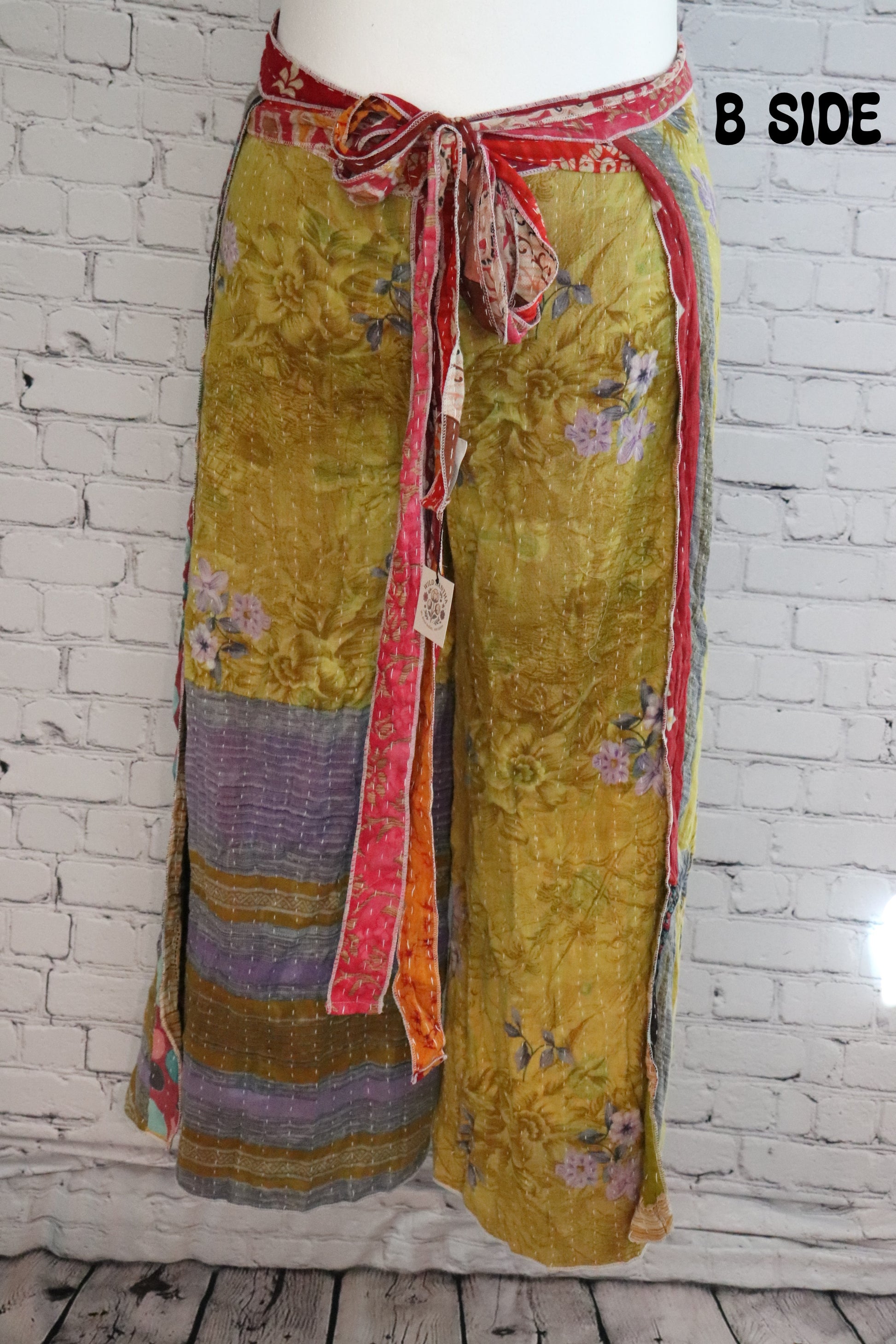 Front view of Ronin Kantha unisex wrap pants, made from recycled sari fabric in boho patchwork design.