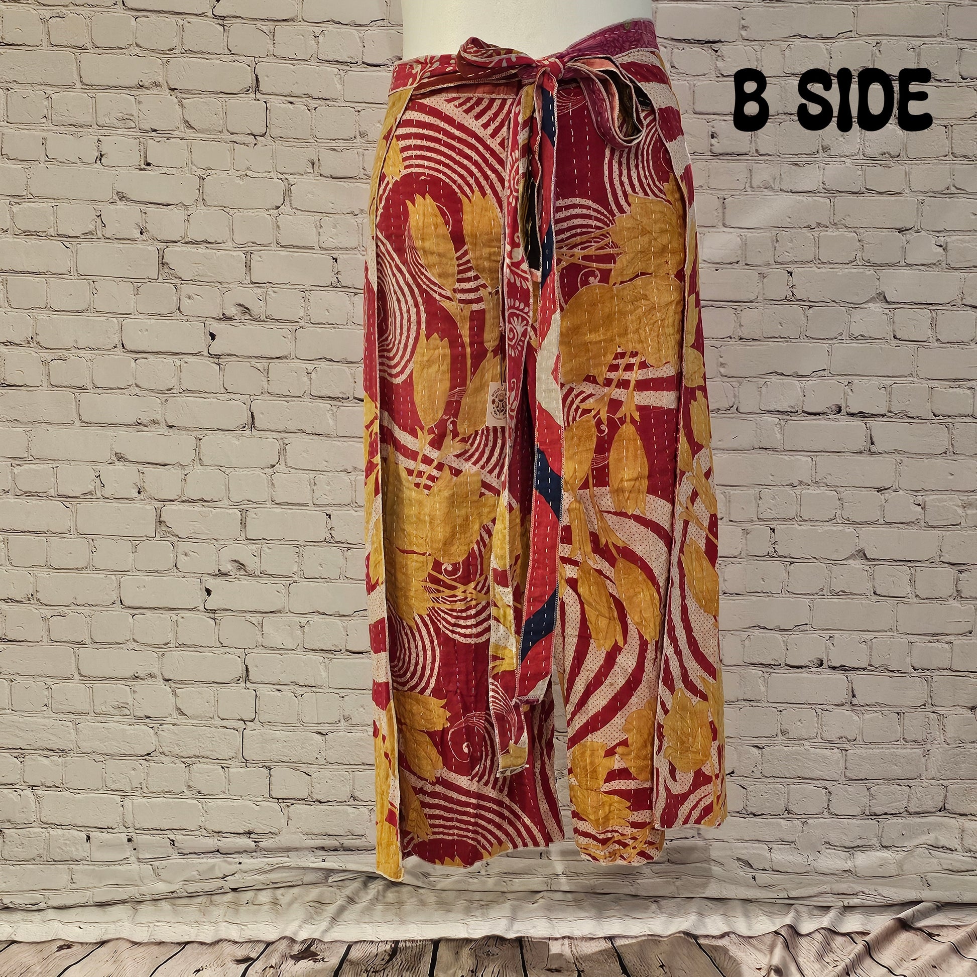 Front view of Ronin Kantha unisex wrap pants, made from recycled sari fabric in boho patchwork design.