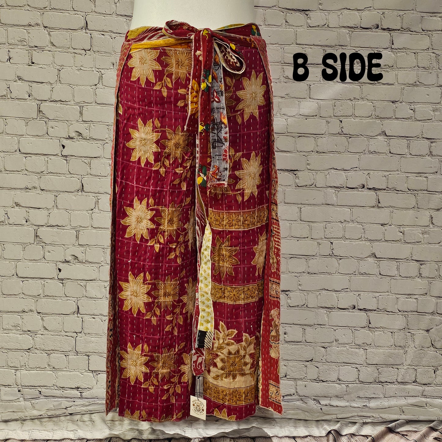 Front view of Ronin Kantha unisex wrap pants, made from recycled sari fabric in boho patchwork design.