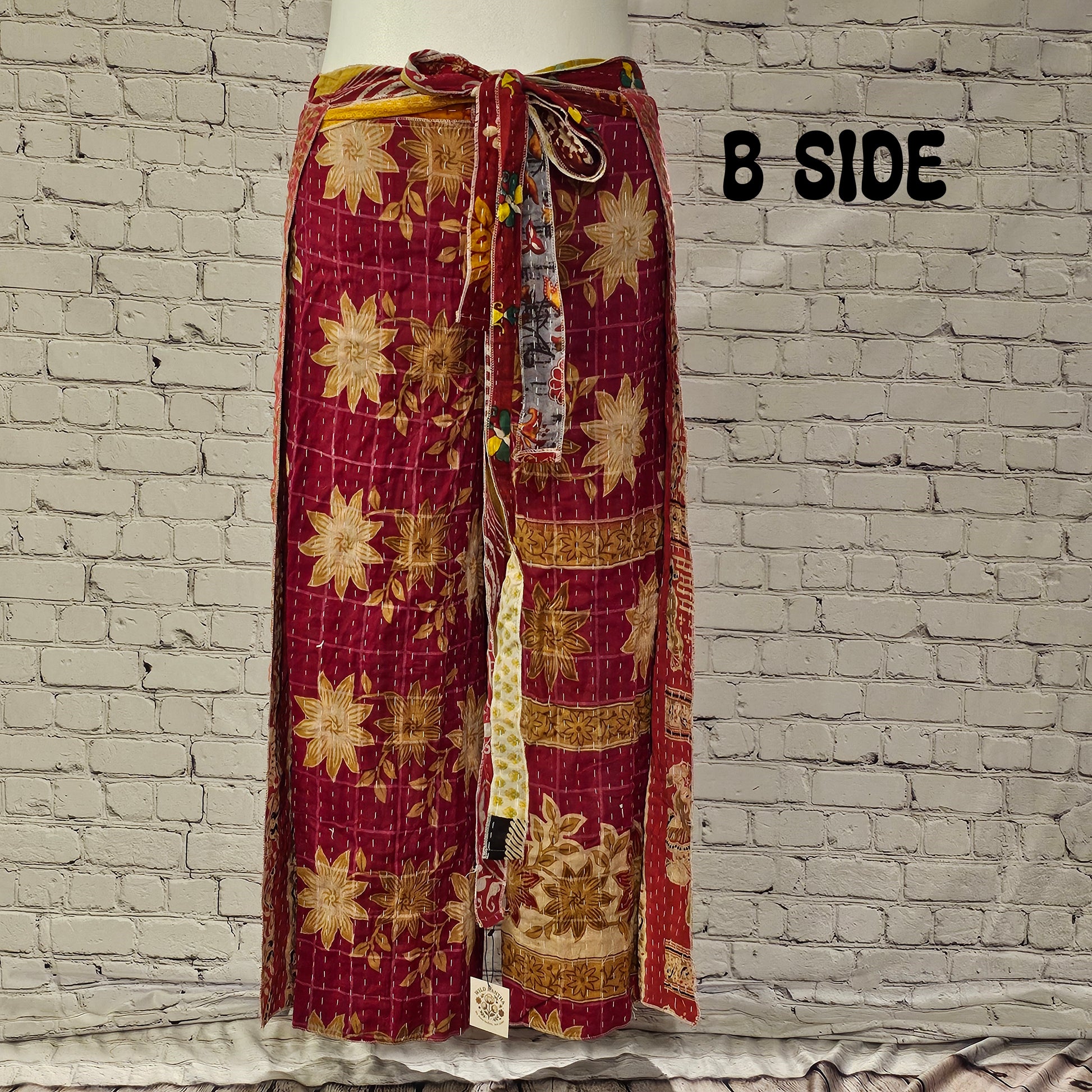 Front view of Ronin Kantha unisex wrap pants, made from recycled sari fabric in boho patchwork design.