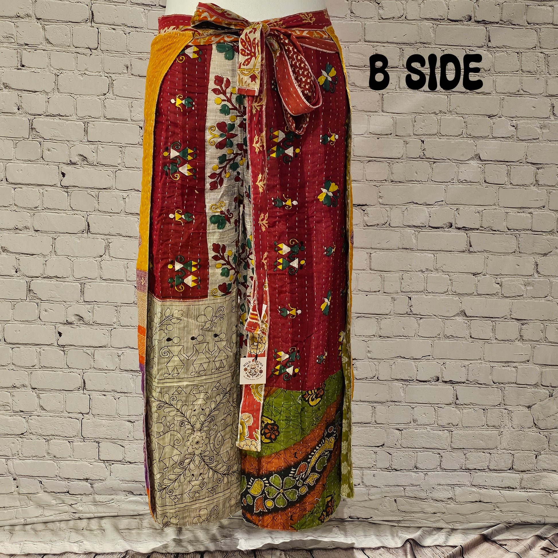 Front view of Ronin Kantha unisex wrap pants, made from recycled sari fabric in boho patchwork design.