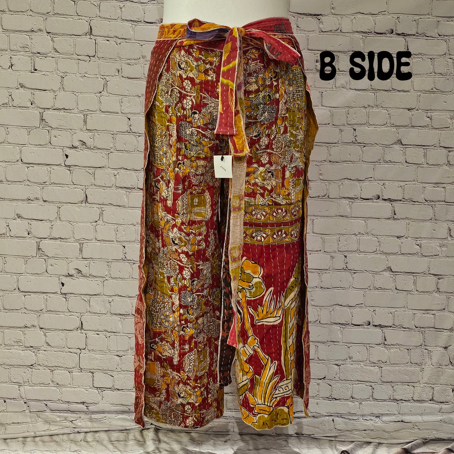 Front view of Ronin Kantha unisex wrap pants, made from recycled sari fabric in boho patchwork design.
