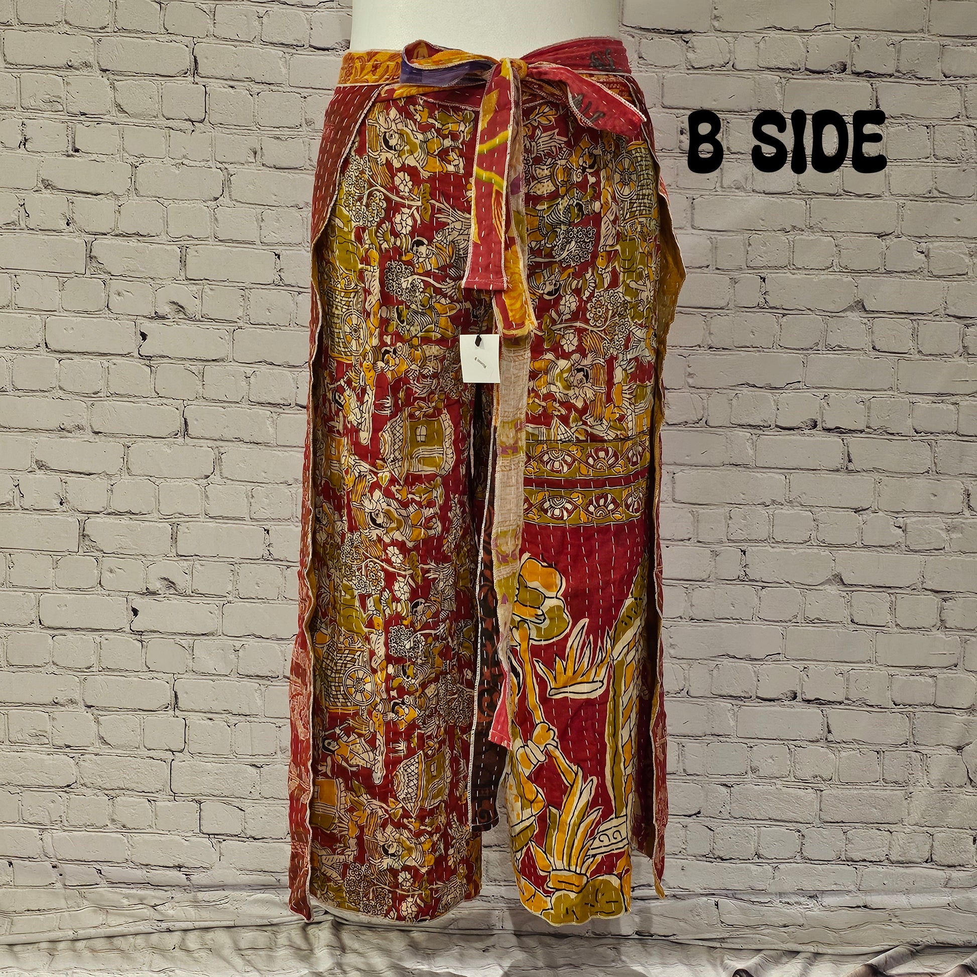 Front view of Ronin Kantha unisex wrap pants, made from recycled sari fabric in boho patchwork design.